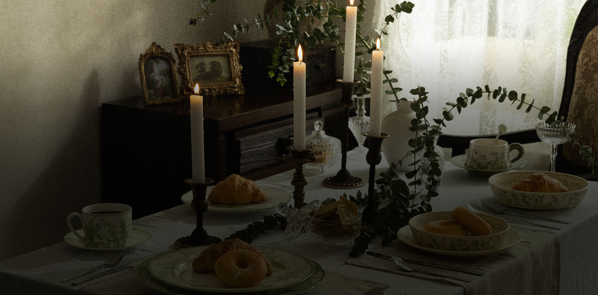 A candlelit table set with Solstice tableware