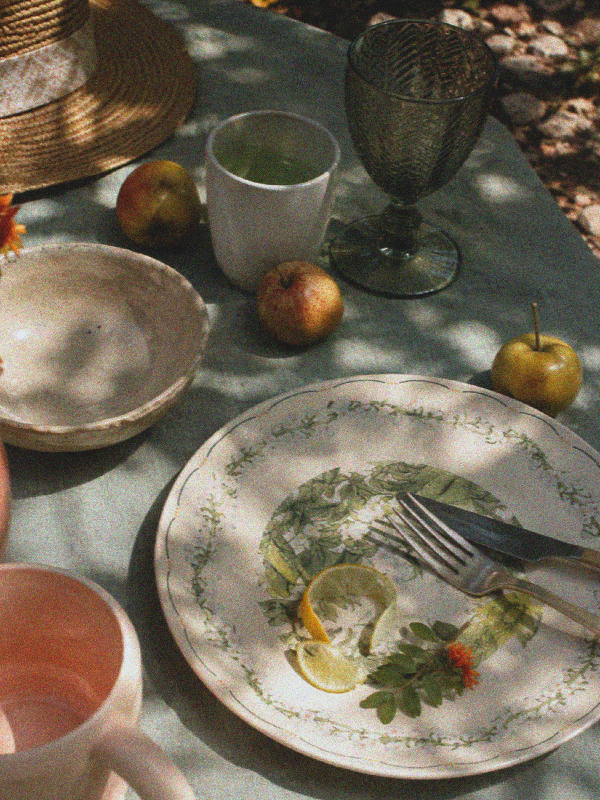 Lily of the valley tableware and glassware on a summer table