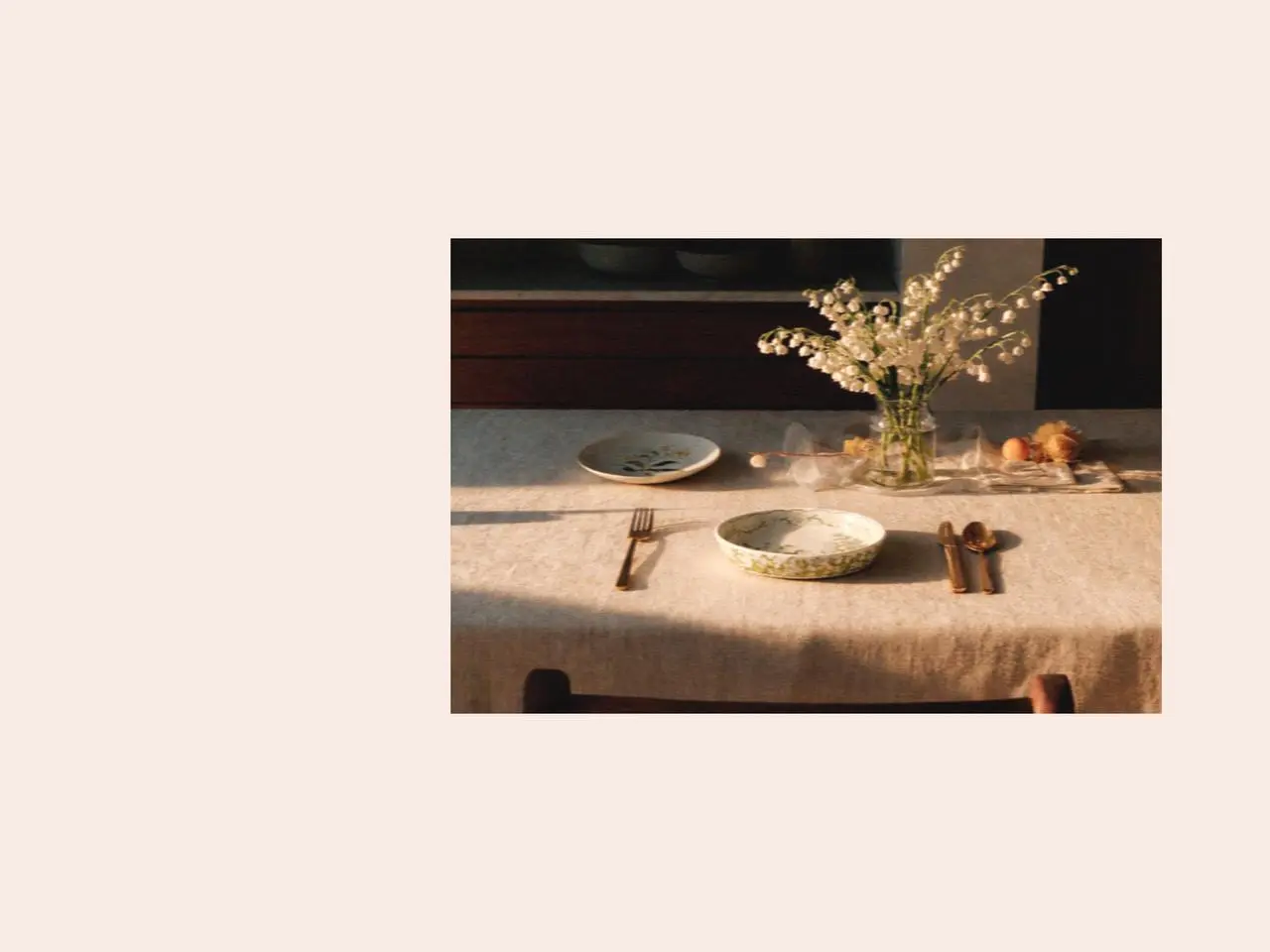 Lily of the valley flowers arranged beside elegant ceramic crockery tableware on a linen table, styled as delicate lily of the valley gifts for a fresh spring garden setting.