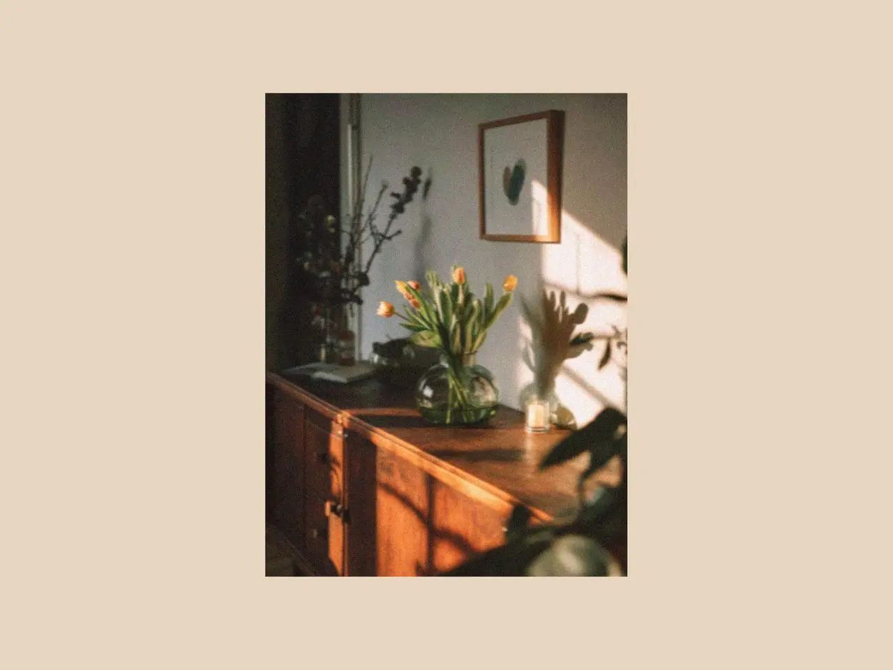 Sunlit wooden table with a vase of fresh tulips and natural greenery, styled as simple decorations for a dining room table reflecting the calm and fresh atmosphere of spring in UK.