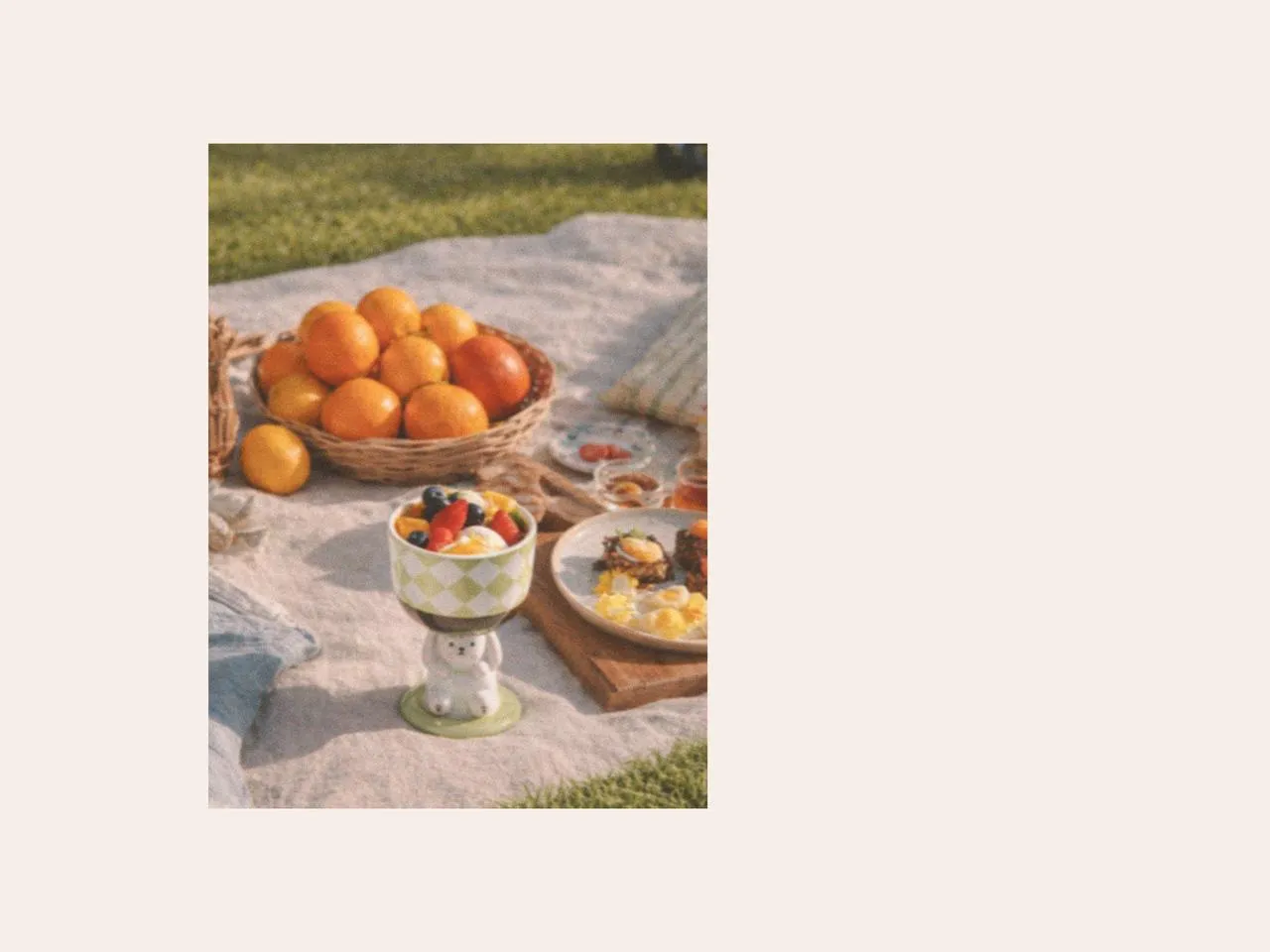 Outdoor picnic dessert setup with easter mugs, easter plates, fresh fruit, and picnic cutlery, styled as playful easter table decorations and creative gift suggestions for easter with designer tableware.