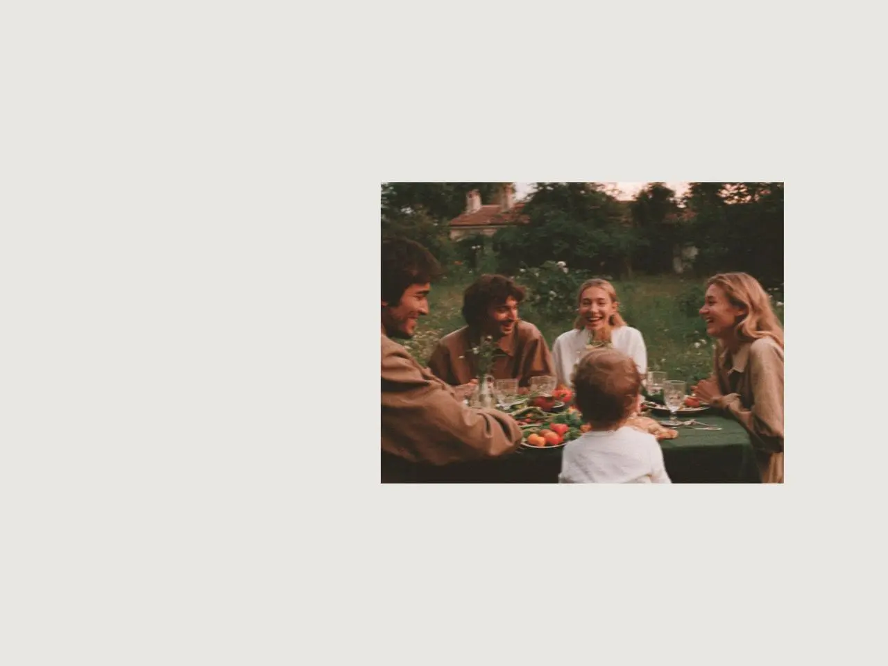 Family enjoying an outdoor meal with easter table decorations, fresh strawberries, and relaxed tableware, creating a sweet easter gathering atmosphere inspired by sunset times for March and spring evenings.