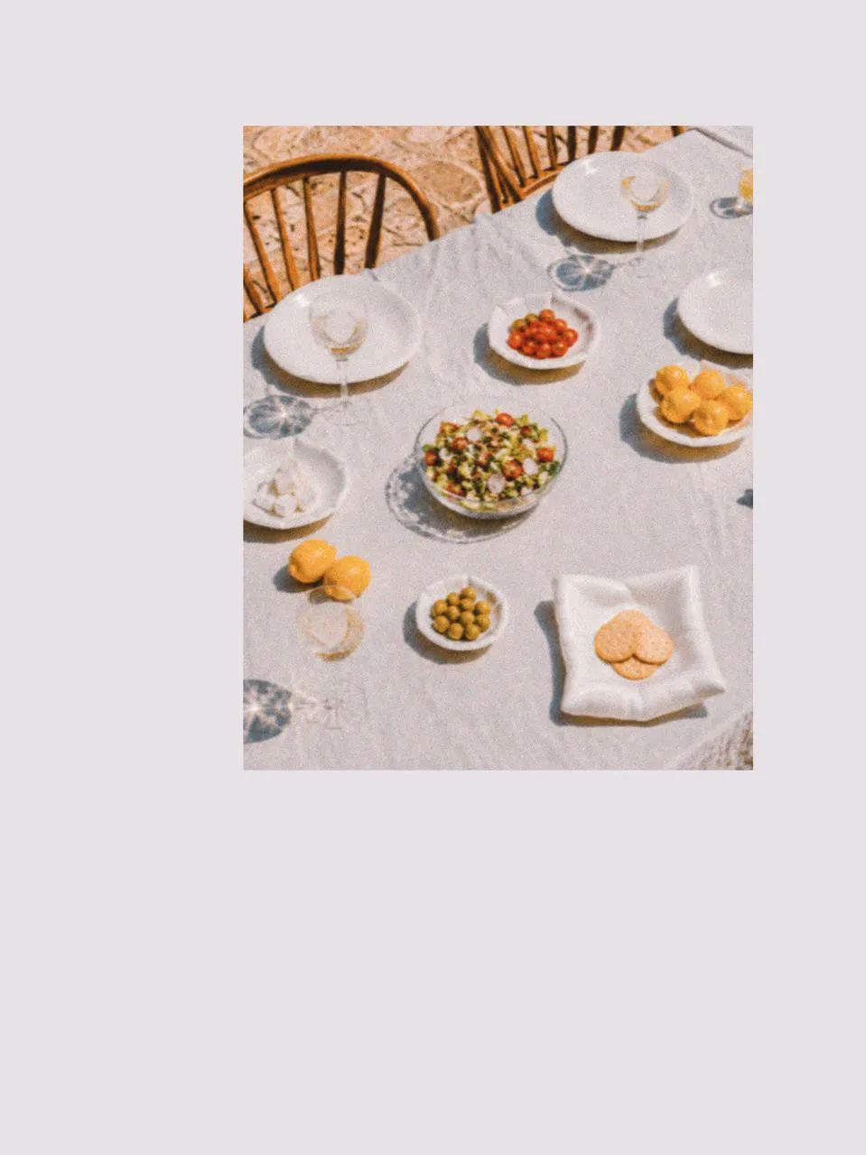 Dining table with a large salad bowl, salad plates, and picnic accessories arranged for sharing, styled with picnic cutlery to create a relaxed family picnic and picnic afternoon tea setting.