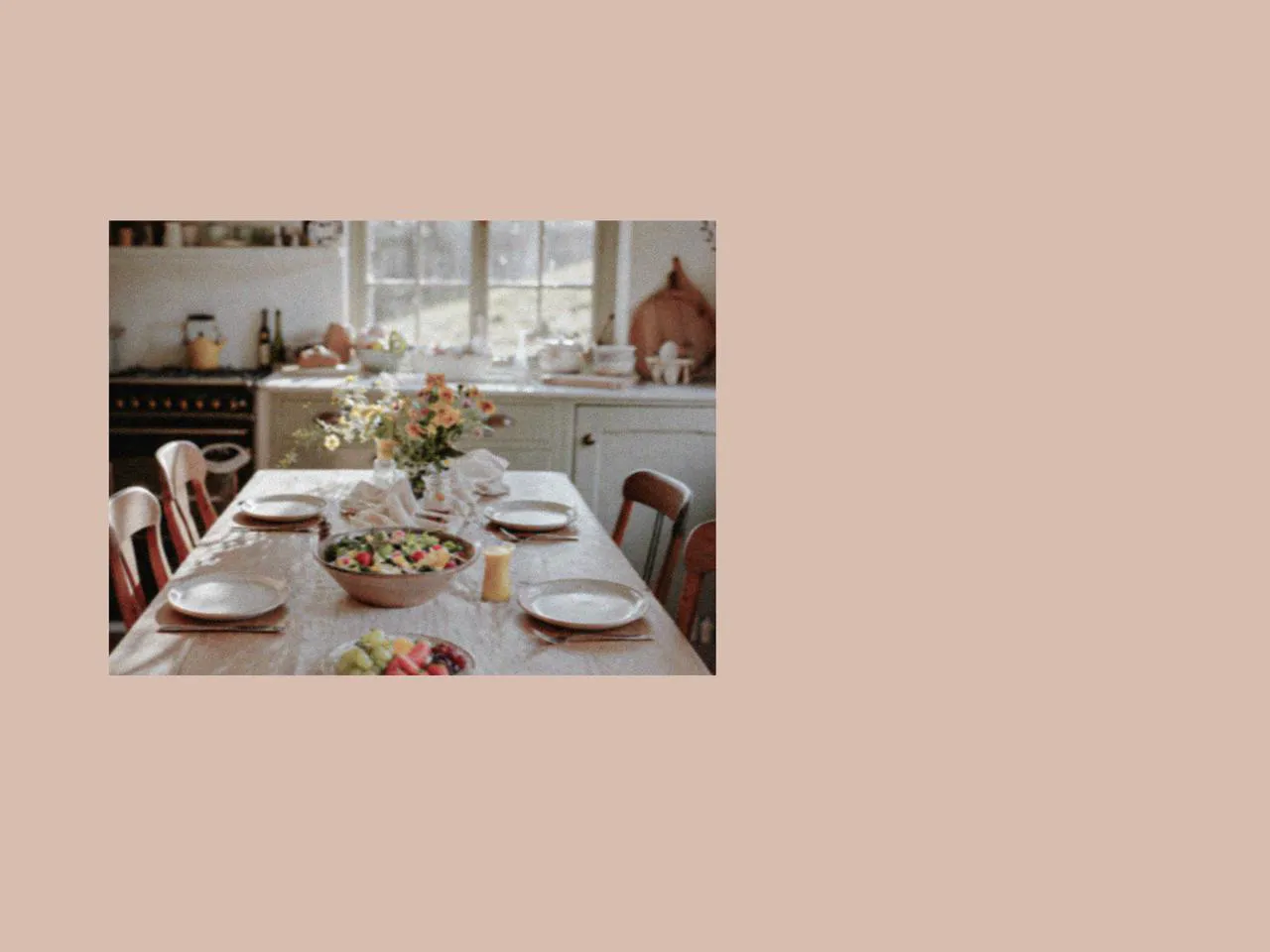 Sunlit dining table with ceramic plate, picnic cutlery, and shared dishes, creating a relaxed indoor setting inspired by a family picnic and picnic afternoon tea during spring in the UK with soft seasonal details.