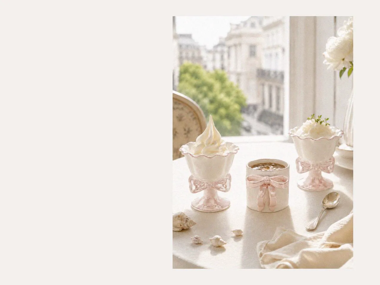 Ceramic mug set with an iced coffee mug and ice cream cups displayed beside beach shells, creating a calm coastal atmosphere perfect for London during summer with elegant ceramic coffee mugs.