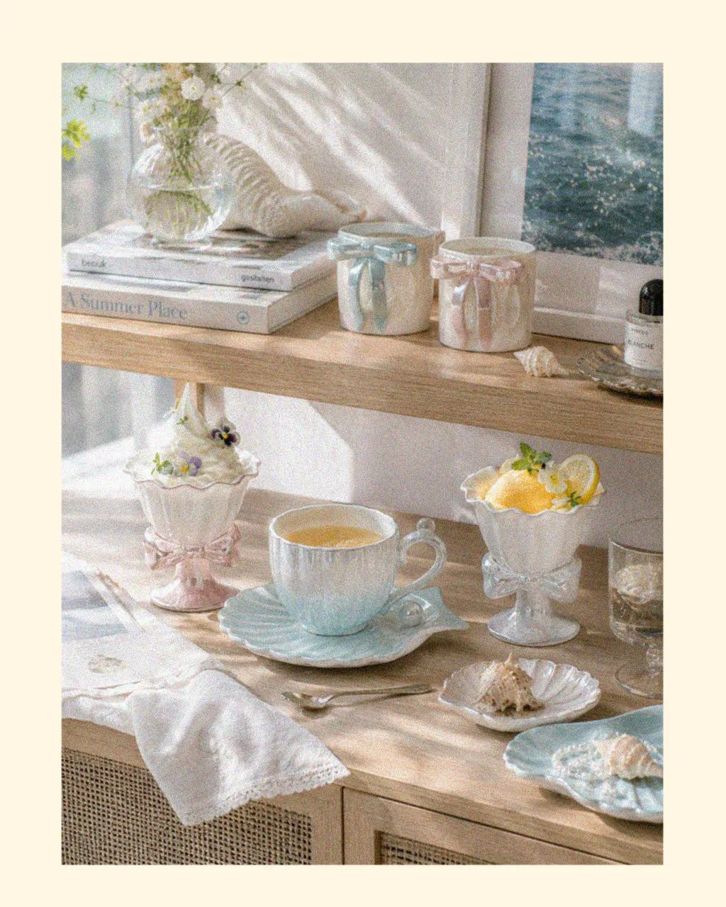 Ocean-inspired designer tableware featuring elegant ice cream cups, versatile hot chocolate mugs, and decorative beach shells in soft coastal colours, creating relaxing things for the summer and a calm seaside atmosphere at home.