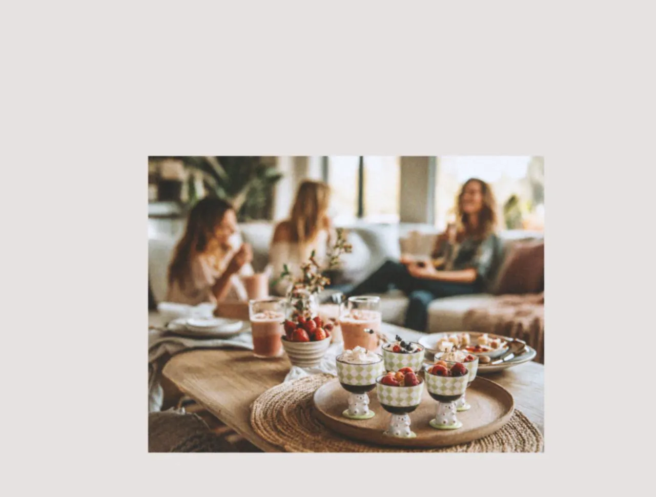 Ice cream cups filled with fruit and desserts arranged on a tray, styled with designer tableware to bring warmth and a relaxed family picnic feeling into everyday home gatherings.