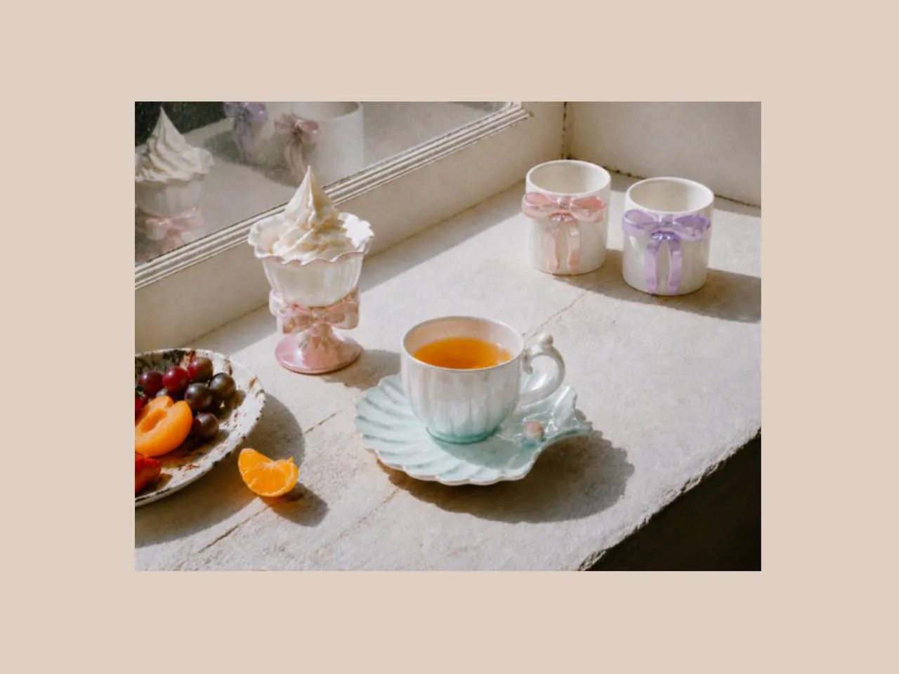 Sunlit table with mugs for latte, ice cream cups, and a designer coffee mug, styled with summery things and soft beach shell inspiration alongside a delicate mugs gift set.